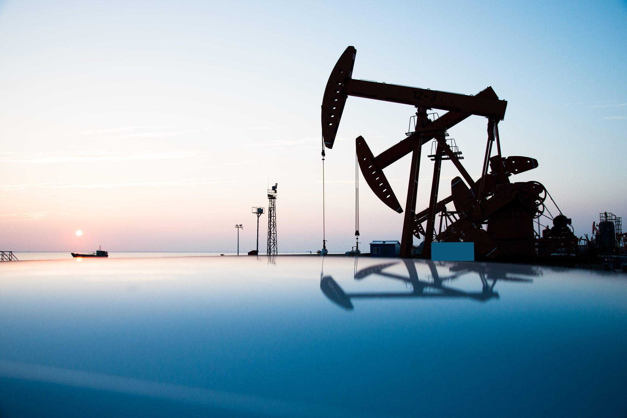 Oil pumps and rig at sunset